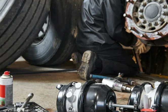 A mechanic checking a tractor before the road